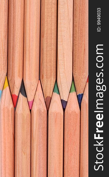 Wooden color pens lined up verticaly