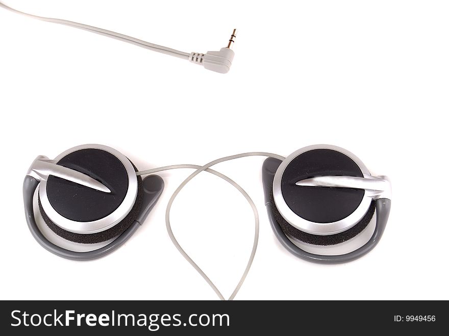 Small easy ear-phones of silvery colour with a cable and the plug.