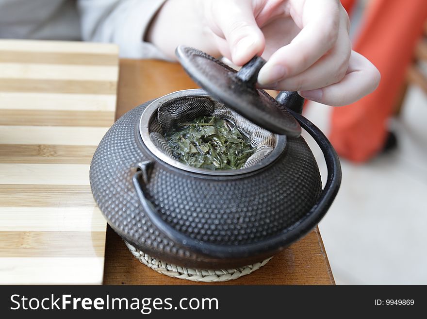 The green tea in a tetsubin teapot. The green tea in a tetsubin teapot