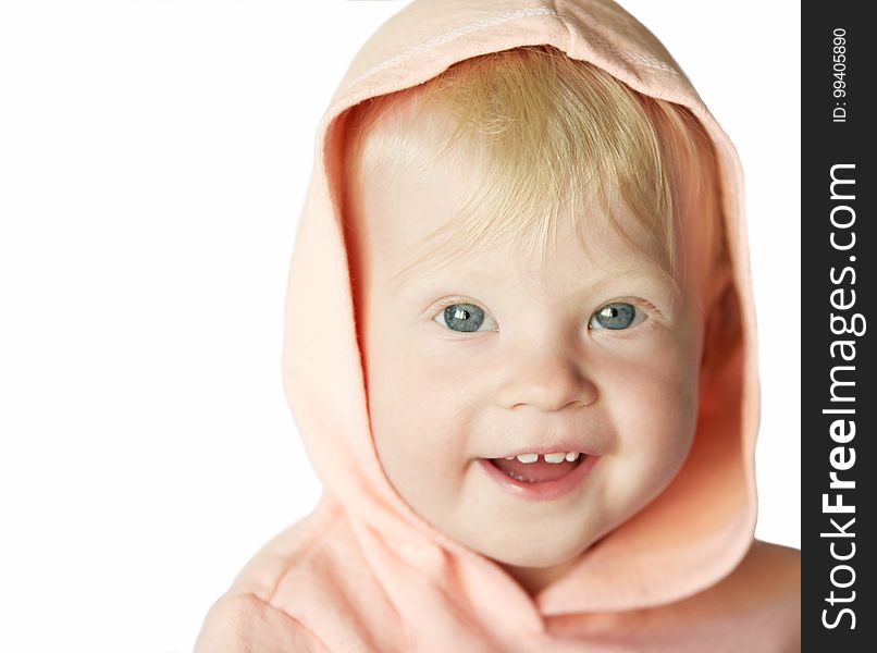 Smiling young blond girl in pink hood in white.