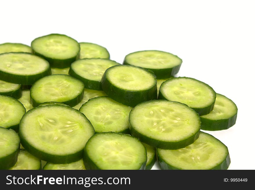Background from slices of a cucumber on white. Background from slices of a cucumber on white