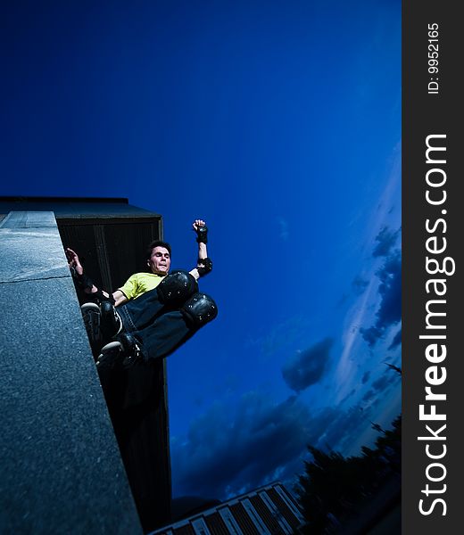 Wide angle photo of a roller performing wall-ride element - photo with a little natural motion blur. Wide angle photo of a roller performing wall-ride element - photo with a little natural motion blur