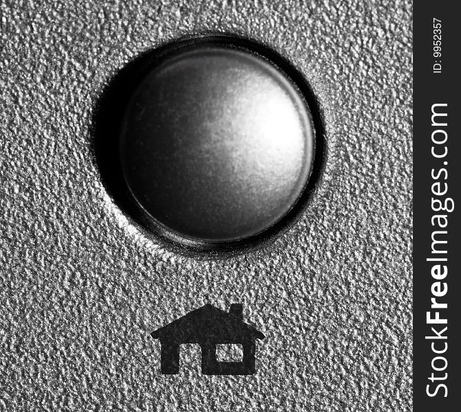 Metallic button with house/home sign underneath, silver color. Metallic button with house/home sign underneath, silver color