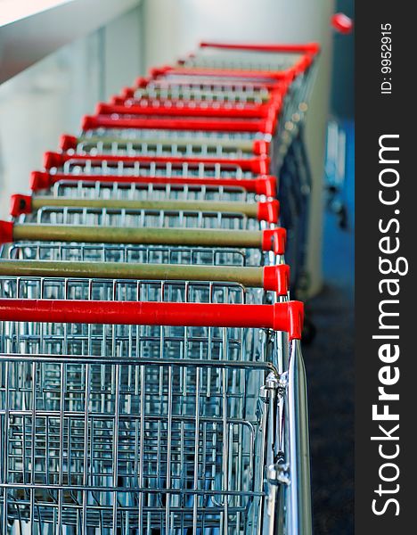 Chain of luggage trolleys in airport