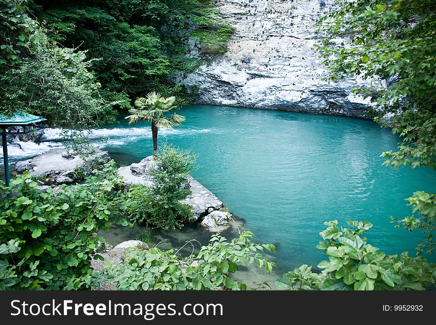 Small lake at a mountain foot. Blue lake. Abkhazia