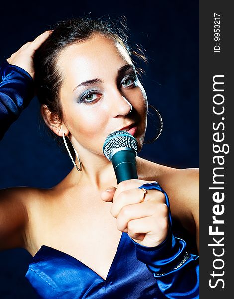 Portrait of sexy young beautiful singer with a microphone. Portrait of sexy young beautiful singer with a microphone