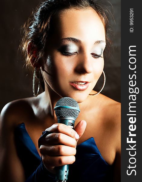 Portrait of sexy young beautiful singer with a microphone. Portrait of sexy young beautiful singer with a microphone