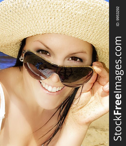 Smiling woman in sunhat on the beach. Smiling woman in sunhat on the beach