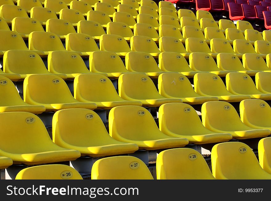 Bright yellow seats in a sports stadium. Bright yellow seats in a sports stadium