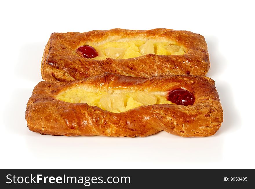 There are two rolls with pineapple and cherry in the picture. Fresh and tasty.