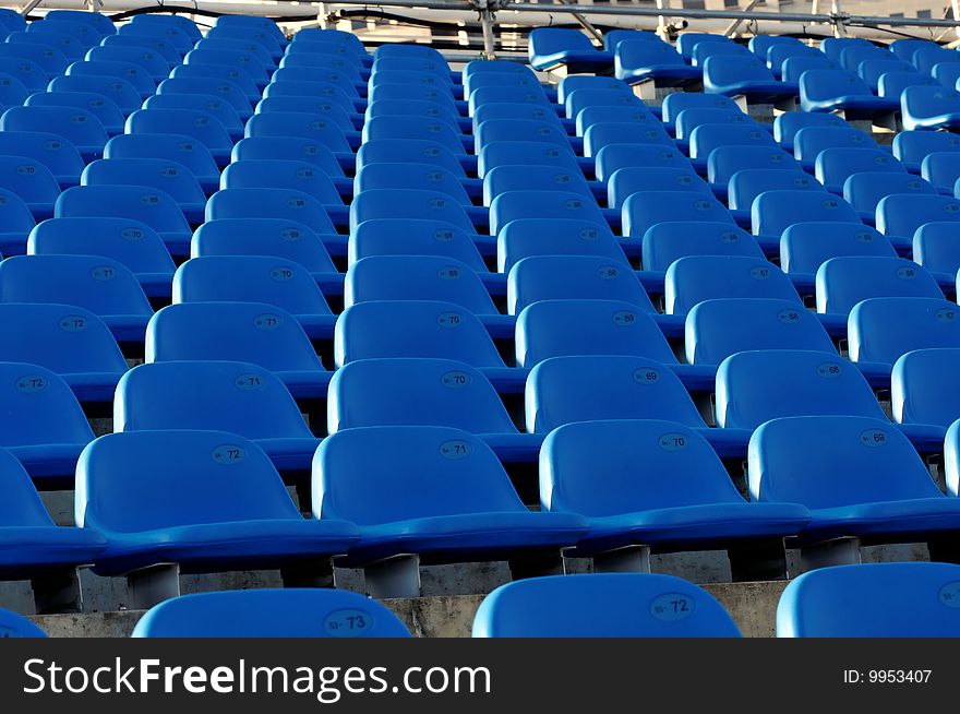 Bright blue seats in a sports stadium. Bright blue seats in a sports stadium