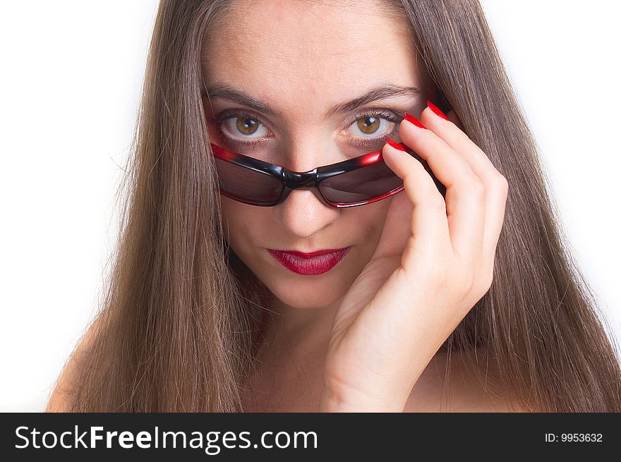 Young woman is staring out over her sunglasses. Young woman is staring out over her sunglasses