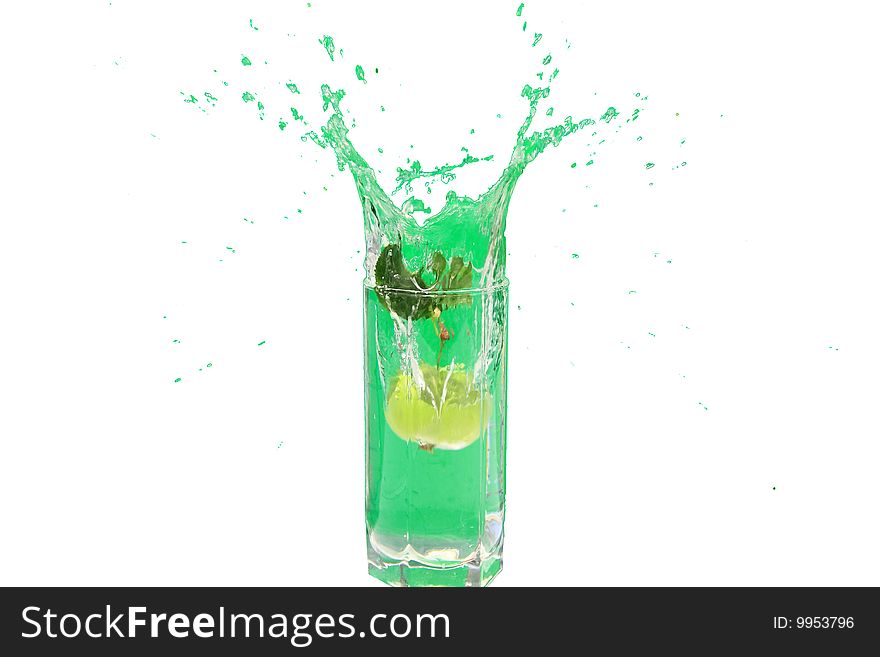 Green apple falls from a tree in a glass of water. Green apple falls from a tree in a glass of water