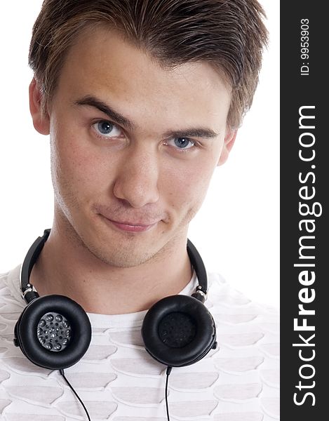 Portrait of young man wearing headphones   against white background. Portrait of young man wearing headphones   against white background