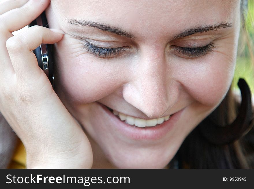 Portrait of Woman, who talks by mobile phone. Portrait of Woman, who talks by mobile phone