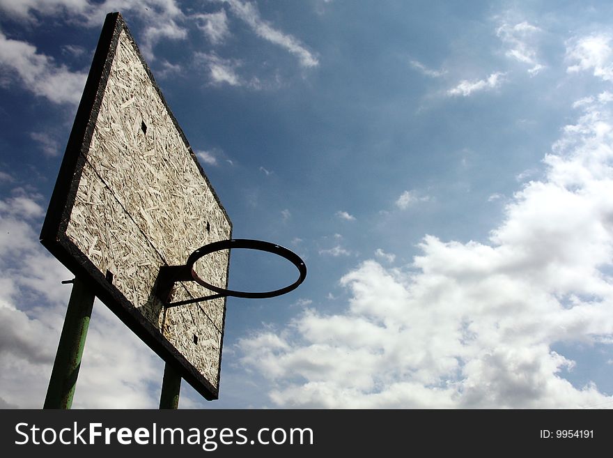 Wooden basketball board in the background of the cloudy sky