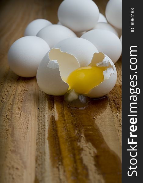 Cracked Egg In Front Of Pile Of Eggs.