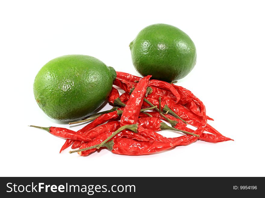 Limes and Hot Peppers isolated against a white background