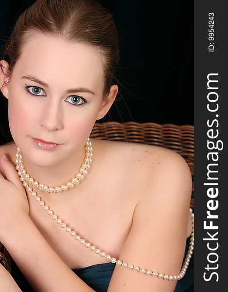 Beautiful female wrapped in fabric, wearing pearls. Beautiful female wrapped in fabric, wearing pearls