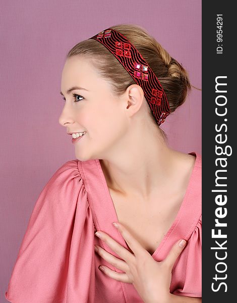 Beautiful blond female model wearing pink dress and hair accessories