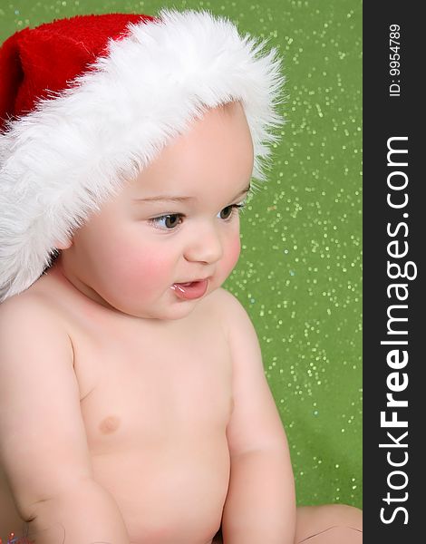 Beautiful christmas baby against a green background