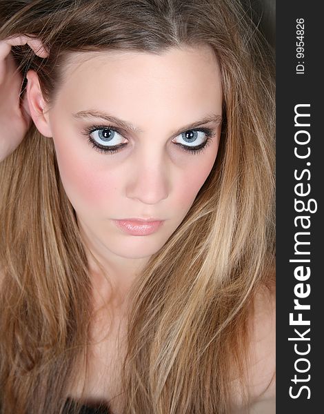 Beautiful female model with blue eyes and dark make up