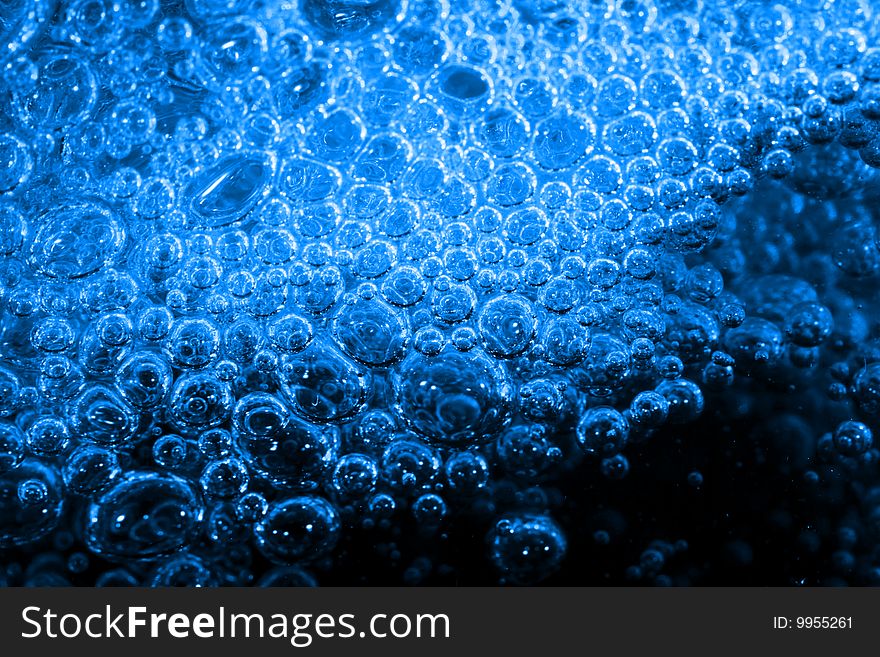 Macro of blue bubbles against black background