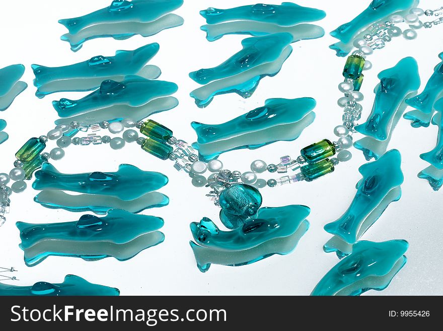 Azure necklace in water with candy dolphins. Azure necklace in water with candy dolphins