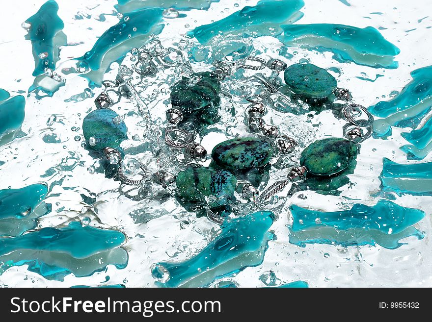 Azure necklace splash in water. Azure necklace splash in water