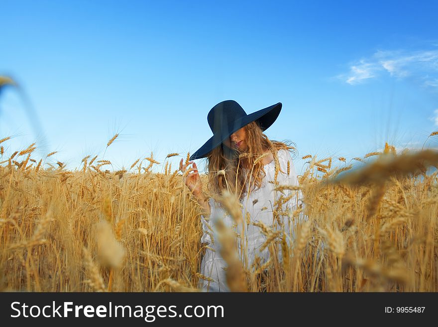 Woman with black hat in wheat field. Woman with black hat in wheat field