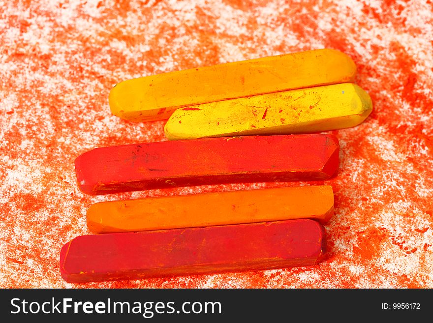 Red macro of pastel sticks isolated