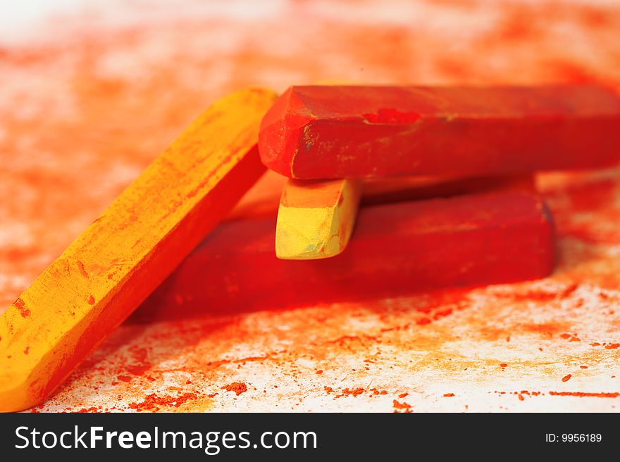 Red macro of pastel sticks isolated