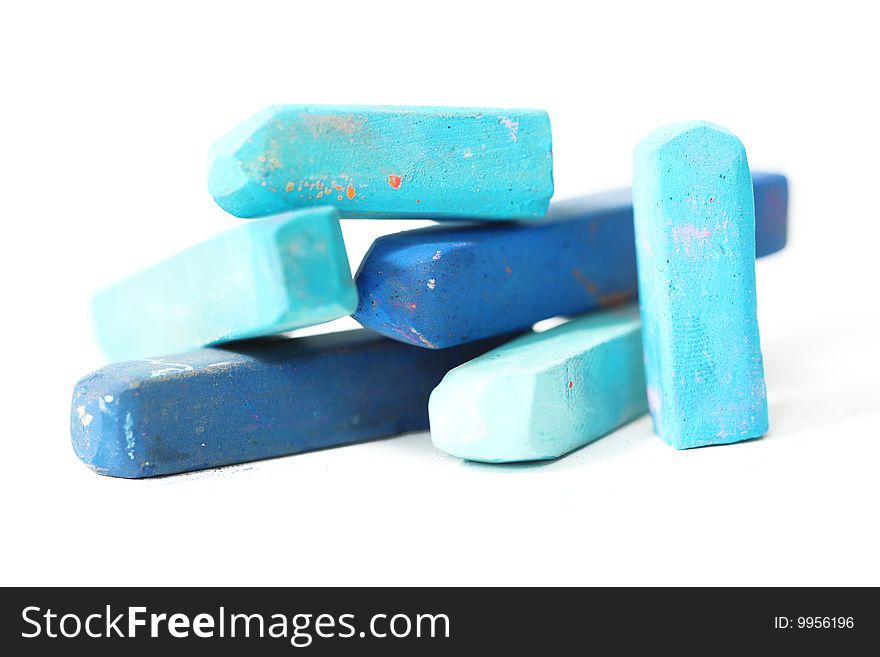 Blue macro of pastel sticks isolated