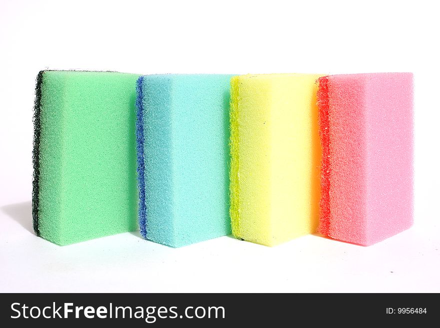 Synthetic sponge for washing dishes. Close-up, isolated on a white background. Synthetic sponge for washing dishes. Close-up, isolated on a white background.