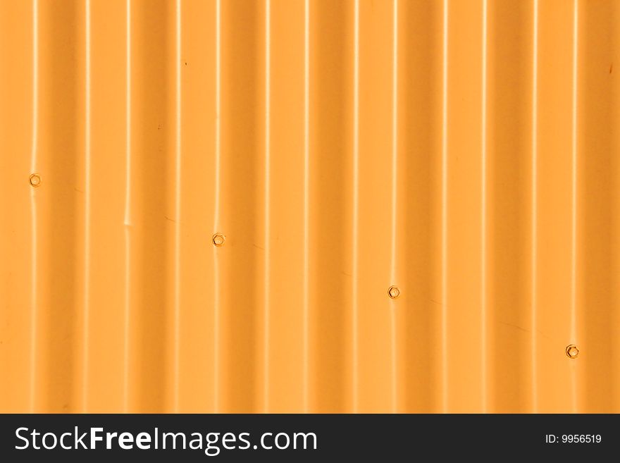 Background - Orange Corrugated Iron Fence with Four Diagonal Bolts. Background - Orange Corrugated Iron Fence with Four Diagonal Bolts