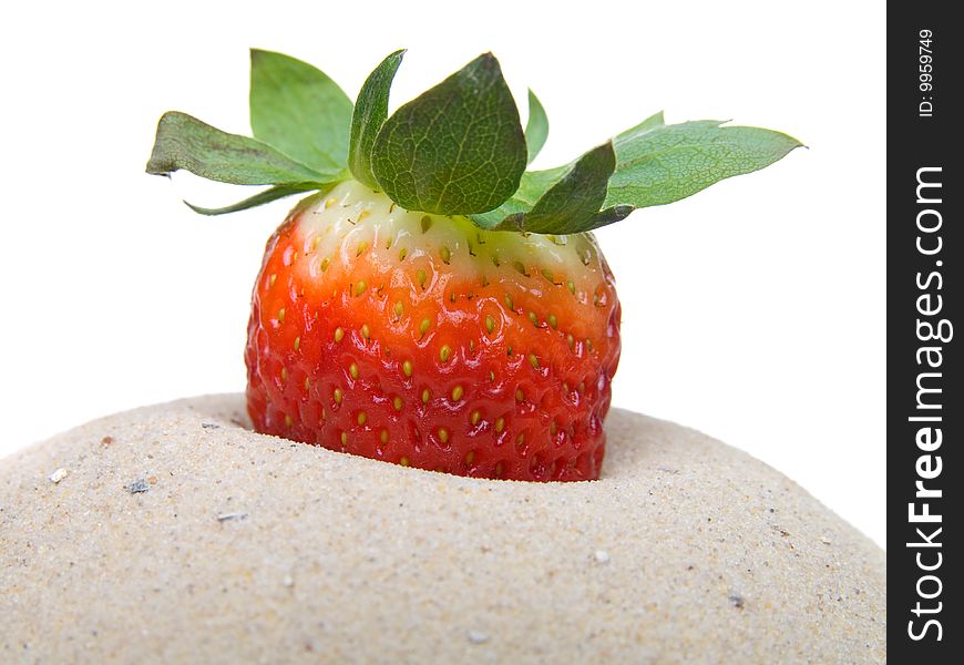 Strawberry in sand  isolated on white background.