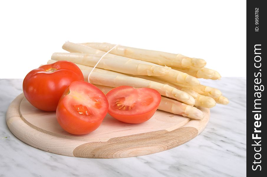 Fresh asparagus and tomatos isolated on white background.