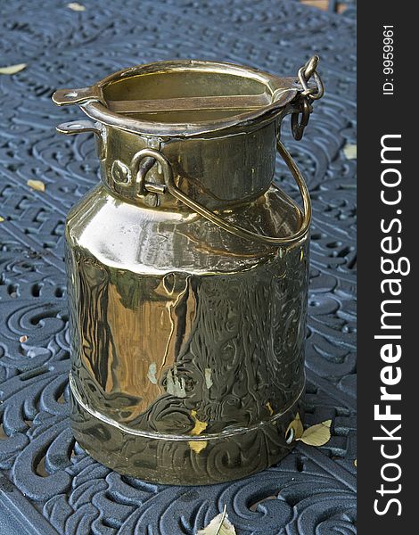 A vintage brass plated milk pail or milk container used to transport milk from farms in South Africa. A vintage brass plated milk pail or milk container used to transport milk from farms in South Africa