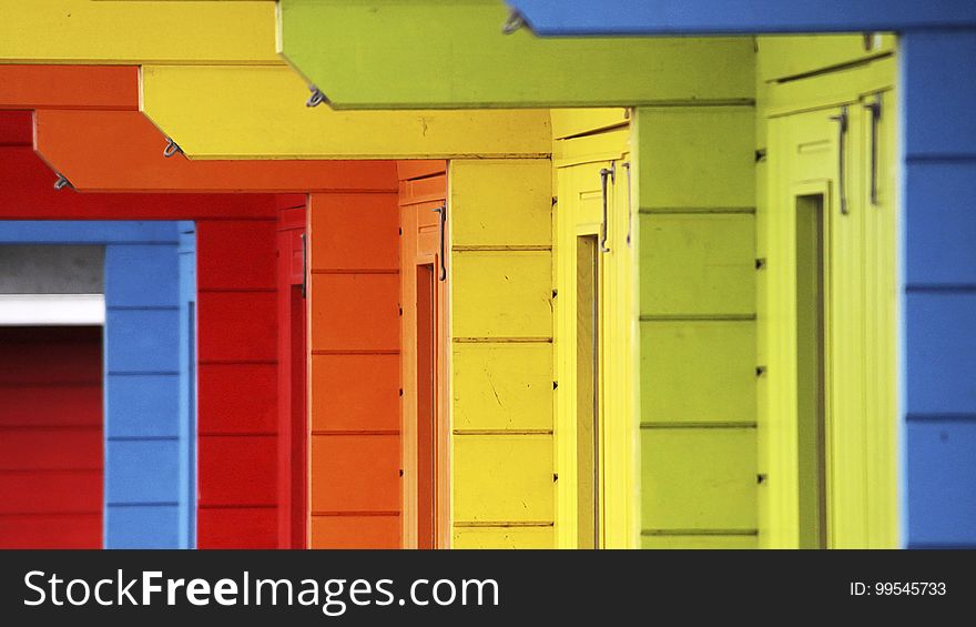 A closeup of homes painted in different colours. A closeup of homes painted in different colours.