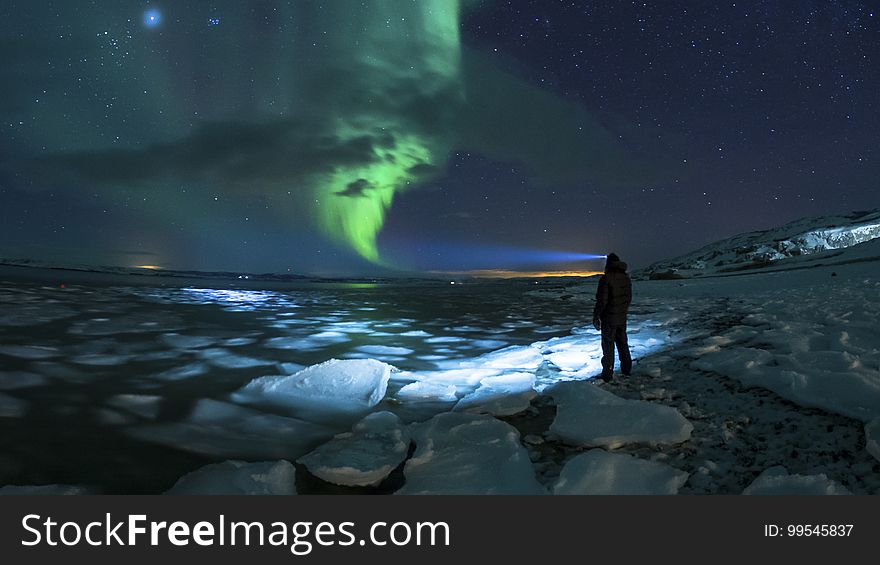 Man on an ice floe watching aurora on the sky. Man on an ice floe watching aurora on the sky.