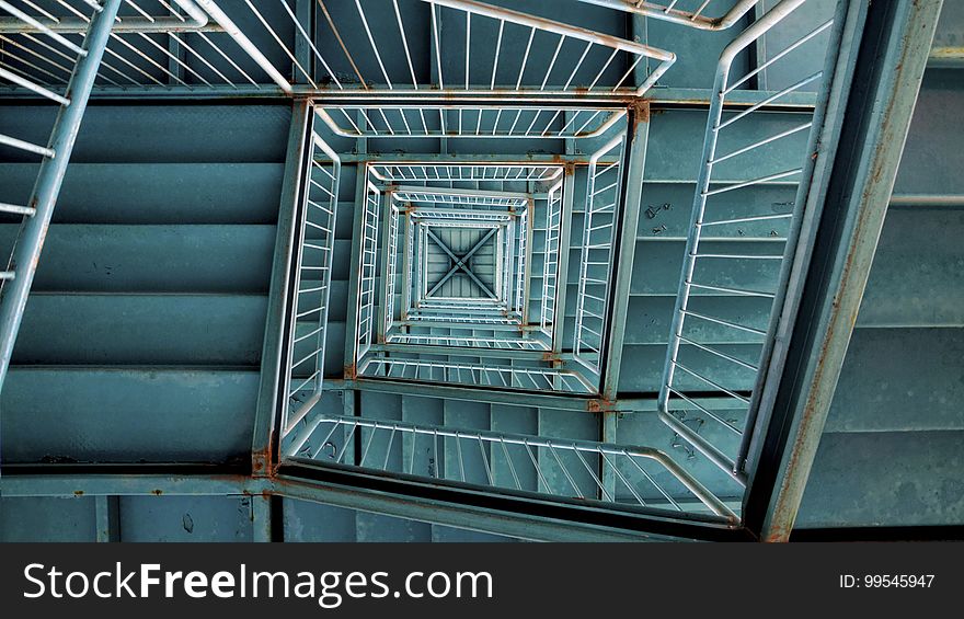 A winding staircase and a stairwell seen from below. A winding staircase and a stairwell seen from below.