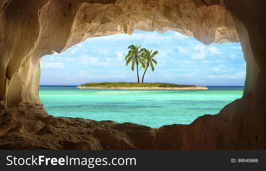 An old Indian cave located on a remoteTurks and Caicos Island. Beautiful Caribbean sea glowing and warm sunlight bathing some remote palm trees on a deserted island. An old Indian cave located on a remoteTurks and Caicos Island. Beautiful Caribbean sea glowing and warm sunlight bathing some remote palm trees on a deserted island.