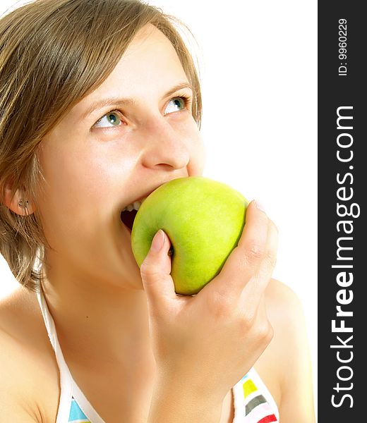 Biting a fresh green apple