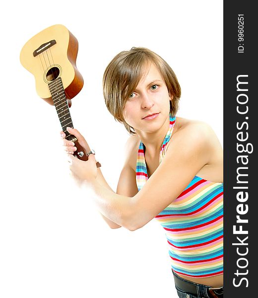 Portrait of a pretty Caucasian blond girl with a nice colorful striped summer dress who is angry and she want to fight with an ukulele (small Hawaiian guitar). Isolated on white. Portrait of a pretty Caucasian blond girl with a nice colorful striped summer dress who is angry and she want to fight with an ukulele (small Hawaiian guitar). Isolated on white.