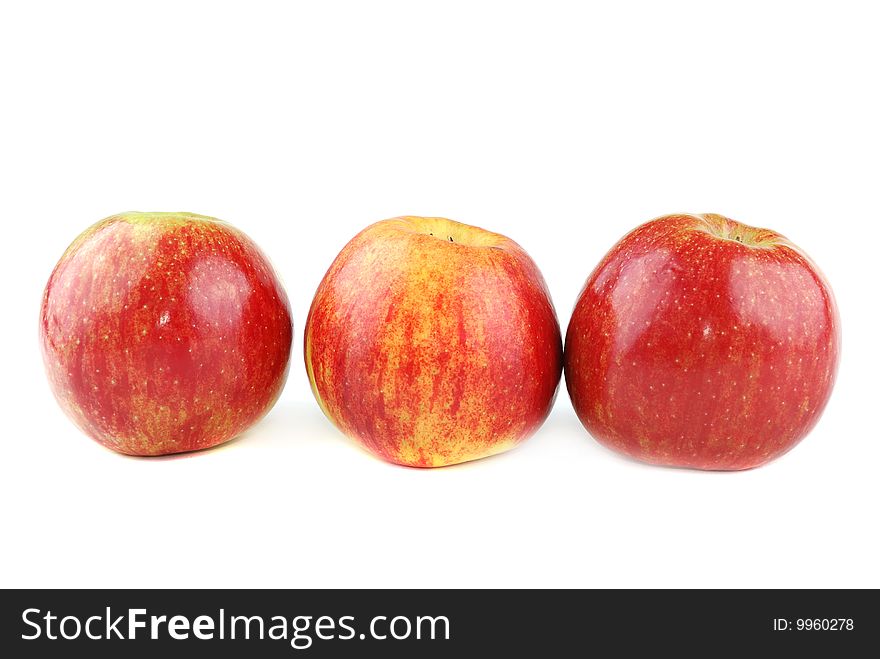 Red juicy apples with yellow points on sides.