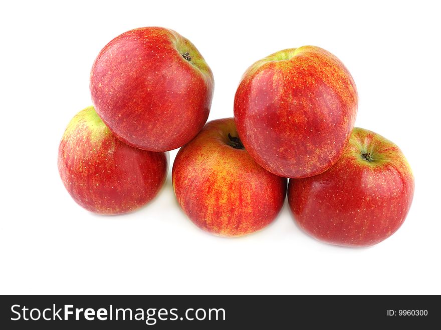 Red juicy apples with yellow points on sides.