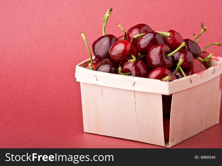 Quart of ripe cherries in a wood container. Quart of ripe cherries in a wood container