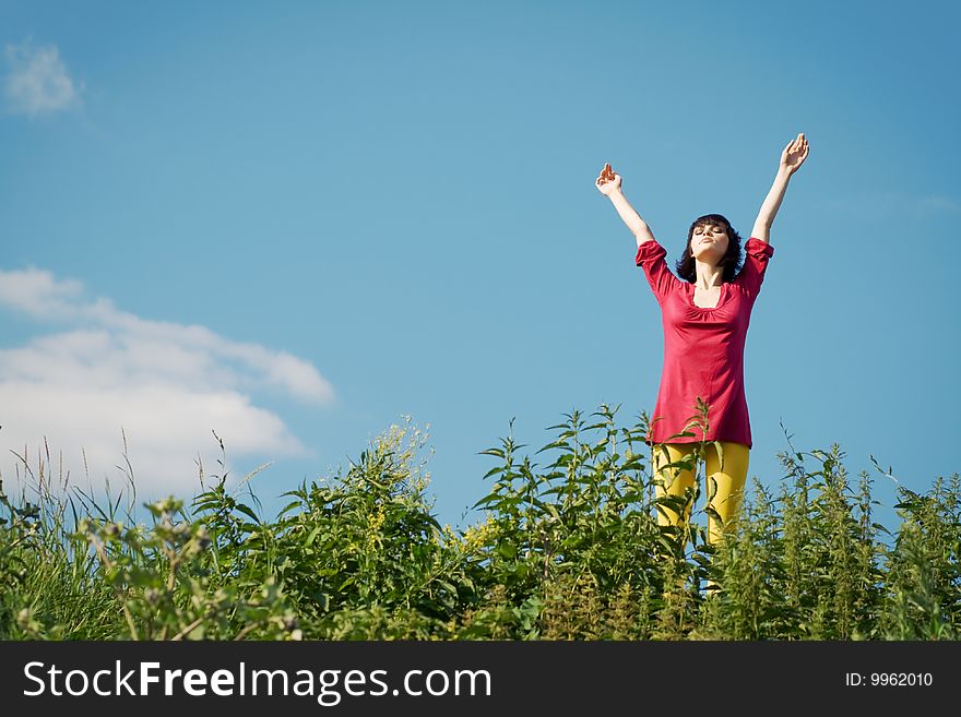 Girl on the meadow against the background of blue sky. Girl on the meadow against the background of blue sky.