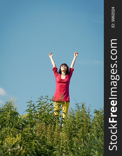 Girl On The Background Of Blue Sky.