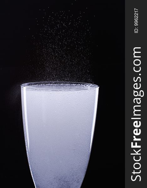 Glass with bubbles on a black background